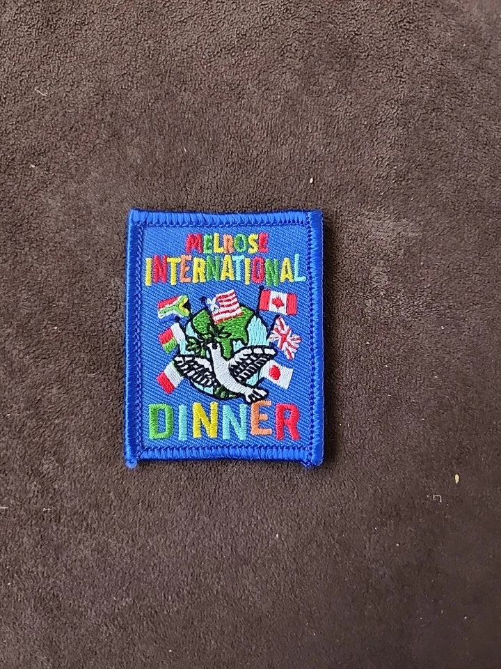 Melrose International Dinner Patch  Iron On Sew On Cloth Blue Patch. M4 - Image 1 of 1