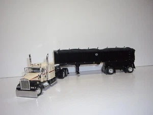 DCP PRIMERA MARCHA 1/64 BEIGE Y NEGRO KW W900L CON DUMMIENTE Y EJE EXTENDIDO MAC CARBÓN DUMP - Imagen 1 de 14