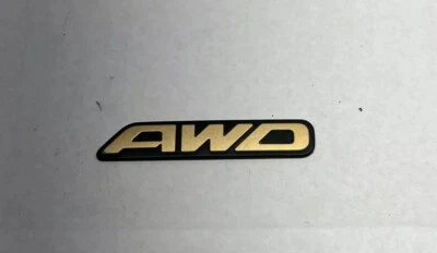 Subaru OEM 2000-2003 Outback Limited "AWD" Gold Rear Trunk Lid Emblem Logo Badge - Image 1 of 2