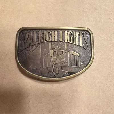 Vintage Raleigh Lights Brass Belt Buckle With Semi Truck Design - Image 1 of 3