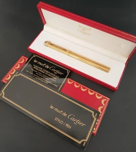 Bolígrafo vintage MUST de CARTIER TRINITY dorado con caja - Imagen 1 de 5