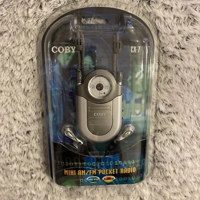 New Coby CX-7 Mini AM FM Pocket Radio DBBS Earphones Silver Neck Strap Music NIP - Image 1 of 2