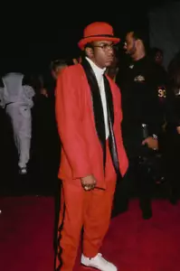 Bobby Brown wears a red suit with black lapels over a white turtle- Old Photo - Picture 1 of 1