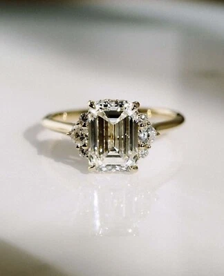 2.75 Carat Emerald Cut Moissanite Ring With Round Cut Accent Moissanite In Gold - Image 1 of 4
