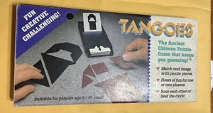 Tangoes Das alte chinesische Puzzlespiel, das Sie raten lässt. Zum Foto geöffnet - Bild 1 von 4