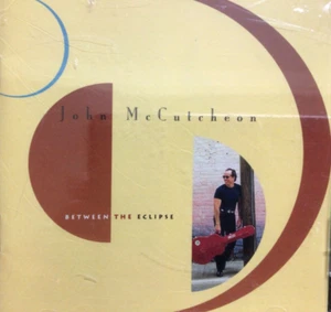 JOHN McCUTCHEON ~ Between The Eclipse ~ CD ~ SEALED - Picture 1 of 3