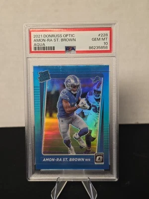 Panini Donruss Optic Amon-Ra St. Brown Aqua Prizm 2024/299 RC #228 PSA 10 Foto 1 de 4