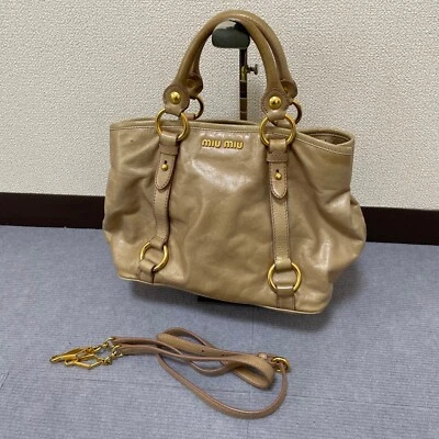 Bolsa bidirecional Miu Miu, bege, couro madras, logotipo - Imagem 1 de 4