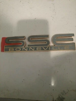 1994-1995 Pontiac Bonneville SSE Door Emblem Nameplate  DARK GREY & GOLD - Image 1 of 2