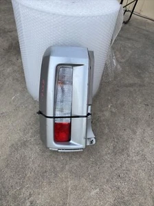 NISSAN ELGRAND 2003 E51 LEFT SIDE TAILLIGHT WITH THE SURROUND SILVER IN COLOUR - Picture 1 of 12