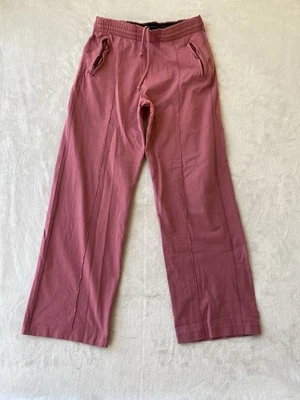 Pantalones deportivos de pierna ancha con logotipo deletreado de Acne Studios, bolsillo trasero M rosa envejecido Foto 1 de 4