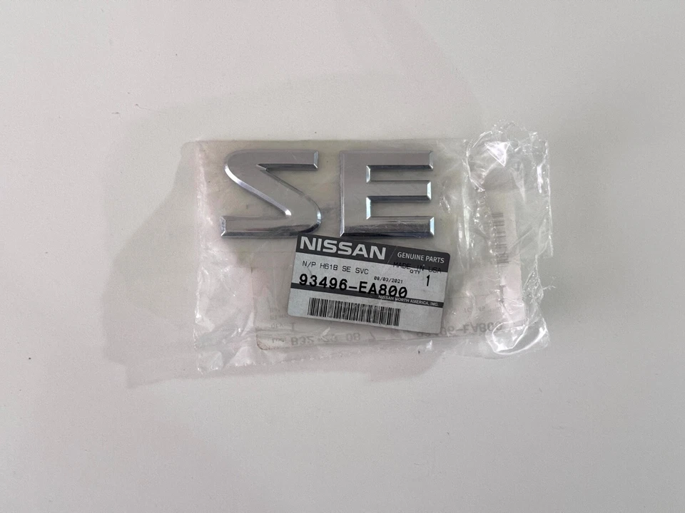 NUEVO OEM NISSAN FRONTIER ARMADA EMBLEMA TRASERO "SE" Parte # 93496-ea800 Foto 1 de 1