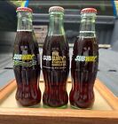 3 bouteilles différentes de Coca-Cola restaurant de métro