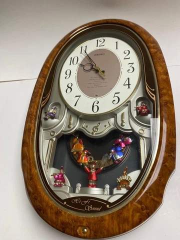 Seiko Wall clock with music battery included.It works excellent brown/white colo Cover