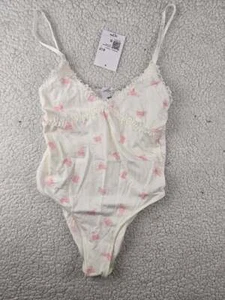 ¡NUEVO CON ETIQUETAS! Camiseta sin mangas para mujer FOREVER 21 talla pequeña blanca y rosa body patines sobre hielo - Imagen 1 de 2