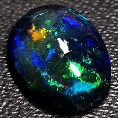 NATURAL AAA+BEAUTIFUL COLORPLAY OVAL CABOCHAN  ETHIOPIAN WELO BLACK OPAL 1.20CTS - Image 1 of 3