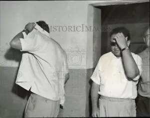 1957 Press Photo Men covering their faces - lra25657 - Picture 1 of 2