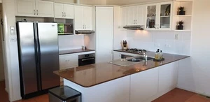 Kitchen cabinets and bench top w/ gas stove top, 2 ovens and 2 rangehoods - Picture 1 of 16