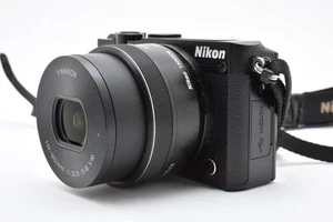 Nikon 1 J5 Mirrorless Camera 10-30mm VR PD-Zoom Lens Kit with Battery Strap - Picture 1 of 10