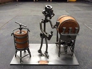 HINA & KUNST (H&K) STEEL SCULPTURE OF MAN MAKING AND BOTTLING WINE - Picture 1 of 3
