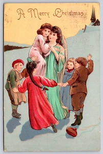 Postcard A Merry Christmas Angel Holding Children Ring Around the Rosy Church - Picture 1 of 2