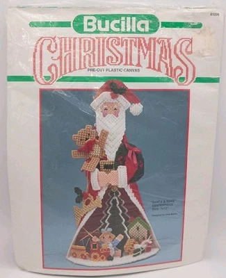 Kit de centro de mesa "Santa y juguetes" de lona de plástico precortado Navidad Bucilla de colección - SIN STOCK Foto 1 de 4