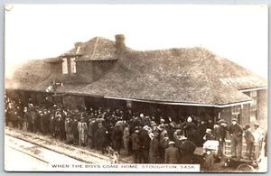 RPPC STOUGHTON Saskatchewan postcard "When the boys come home" Train Depot dog - Picture 1 of 2