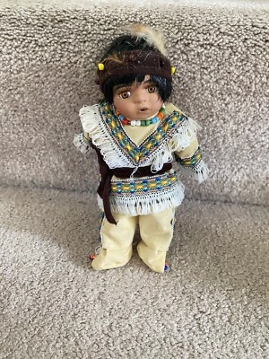 Small Native American Porcelain Doll With Bead Necklace-8” Feather Headdress - Image 1 of 3