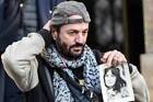 French musician Francis Lalanne holds a picture of late French sin- Old Photo 1