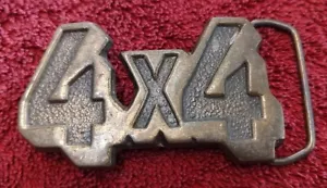 Vintage 1980s 4x4 Belt Buckle Truck Mud Dodge Ford Pickup Ram Off Road Tires - Picture 1 of 3