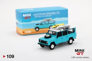 Mini GT, LAND ROVER DEFENDER 110 con tavole da surf, scala 1:64, azzurro #109 - Foto 1 di 6