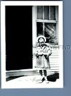 FOUND B&W PHOTO V+0341 GIRL IN COAT AND HAT STANDING BY DOOR