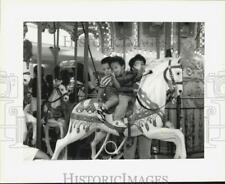 1993 Press Photo Toshika Barnes with Charles Bell and Darrell Smith on carousel