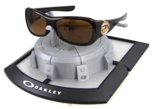 Oakley Flaunt 12-982 Sonnenbrille braun glitzerndes Gestell/braune polarisierte Gläser - Bild 1 von 1