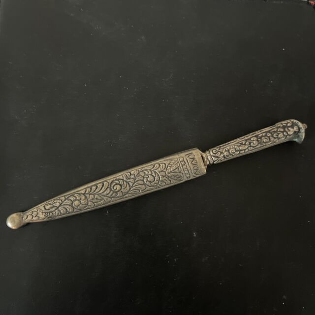 Caucasian qama or kindjal dagger, the 15cm pointed double edged blade with  centre fuller and two-piece horn grip; in nickel plated scabbard with  panels of figures and script L28.5cm overall; and east 