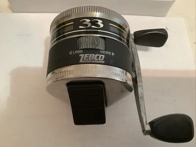 CARRETE SPINCASTING CARA CERRADA A RAYAS NEGRAS ZEBCO #33 VINTAGE HECHO EN EE. UU. Foto 1 de 4