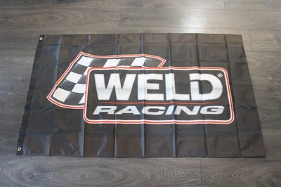 Ruedas de carreras de soldadura bandera piezas de automóviles garaje mecánico hombre tienda de velocidad cueva Foto 1 de 4