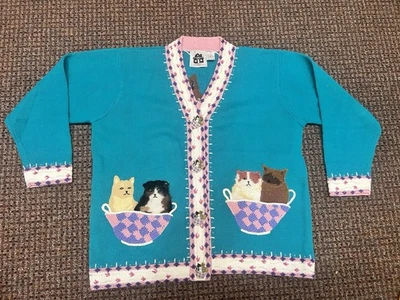 Storybook Knits. It is a novelty sweater featuring embroidered cats in baskets - Image 1 of 4