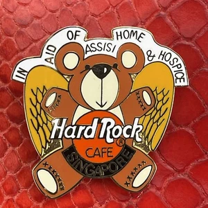 SINGAPUR🎸Hard Rock CAFE®HRC PIN☑️IN AID OF ASSISI HOME & HOSPICE BEAR WINGS🎗 - Bild 1 von 3