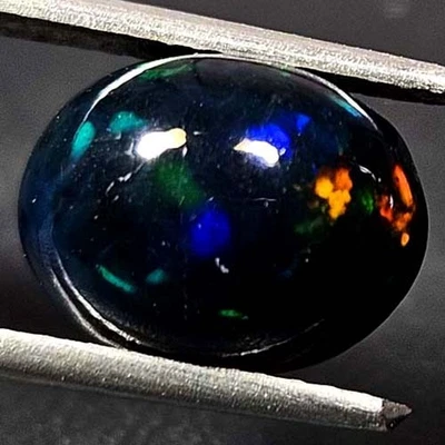 NATURAL AAA+ AMAZING COLOR PLAY OVAL CABOCHAN  ETHIOPIAN WELO BLACK OPAL 2.30CTS - Image 1 of 3