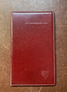 PORSCHE ADRESSHEFT - ECHT LEDER IN ROT MIT STANZ PORSCHE/STRÄHLE CA.17X10 CM - Bild 1 von 4