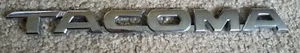 2005 - 2015 Toyota Tacoma Front Door Emblem OEM #75427-04010 - Used - Imagen 1 de 2