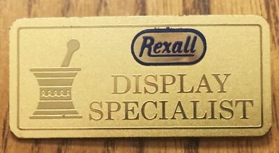 Prendedor de colección Rexall farmacia especialista en exhibición dorado con azul Foto 1 de 2