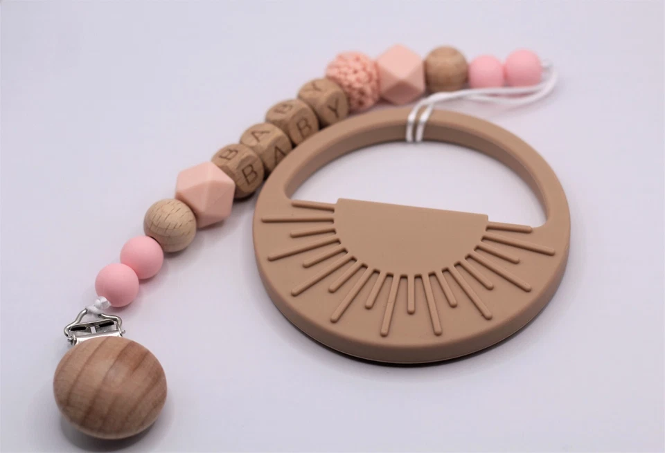 Juguete de dentición de bebé de silicona en forma de sol con clip de madera Foto 1 de 3