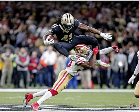 Alvin Kamraa New Orleans Saints Unsigned Hurdling Defender Photograph Cover