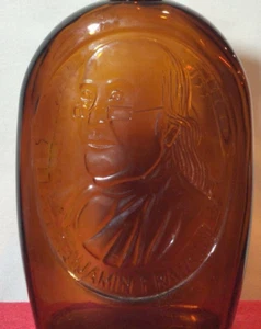 VINTAGE LOG CABIN SYRUP BOTTLE EMBOSSED Ben Franklin face BROWN amber GLASS - Picture 1 of 5