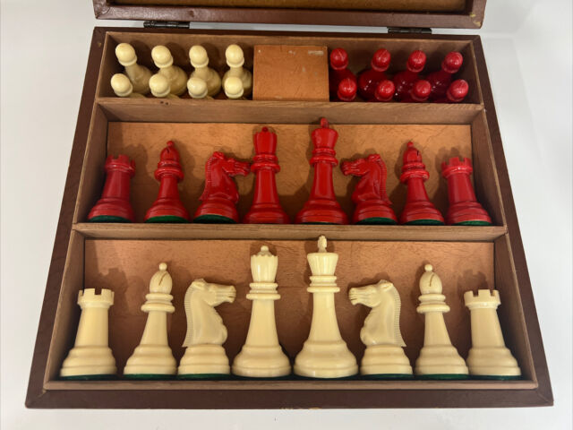 Chess pieces: 32 red and white ivory pieces without board., Complete number  of pieces of a chess game. Sixteen cut ivory pieces that have been made red  with a dyestuff: these are