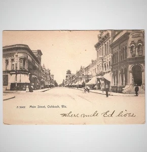 Carro de bicicletas Oshkosh Wisconsin Main Street postal antigua escaparates - Imagen 1 de 3