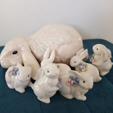 A lot of 6 small rabbits and one large Floppy Earsed white rabbit.