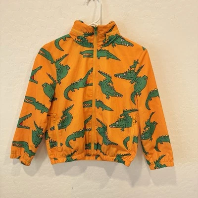 Chaqueta impermeable naranja Stella McCartney niños 10 cocodrilo capucha oculta caprichosa Foto 1 de 4